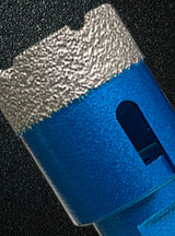 Close view of the gritty rim and side opening of a blue cutter included in the set.