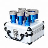 Five blue cup cutters standing on the included closed aluminium storage case.