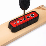 Red multi-hole drill guide block with marked guide bushings shown in use